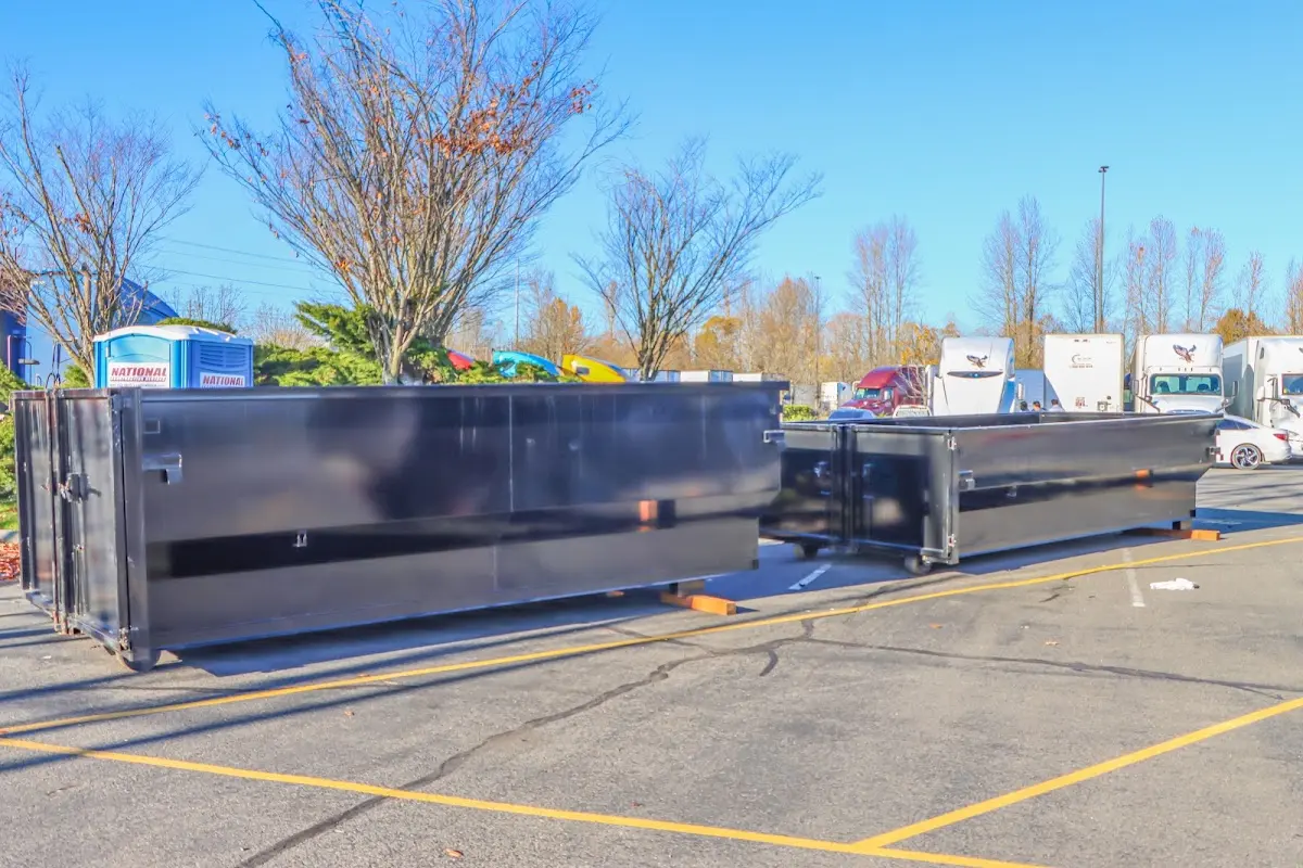 Professional dumpster rental service with roll-off container on residential driveway in Arden Hills